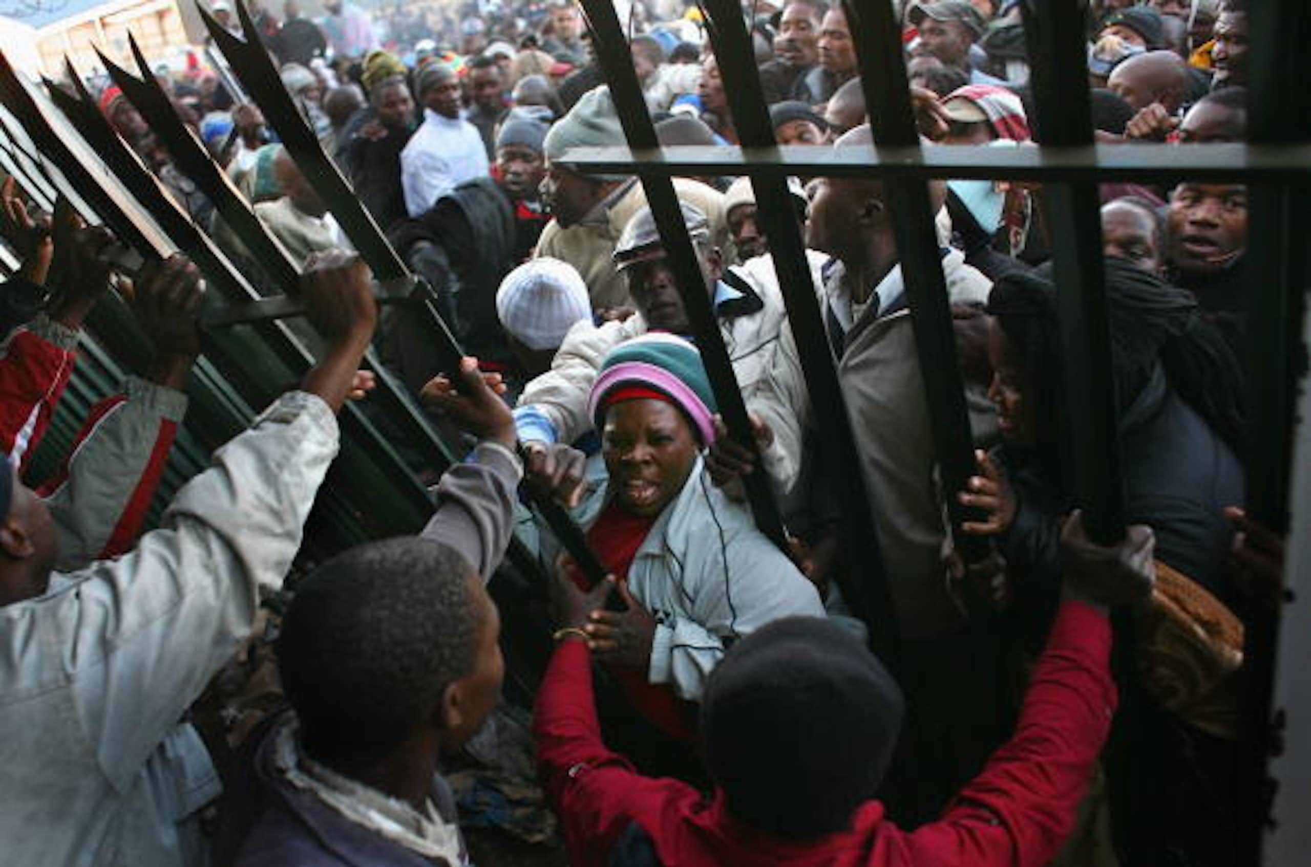Hundres of men anmd women storm an asylum permits centre.